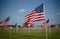 Powerful shot of a Large Patriotic Display with hundreds of American Flags in grass field