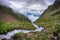 Powerful stream of mountain river running down the valley