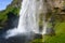 Powerful stream of Seljalandfoss waterfall