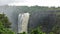 A powerful stream of water breaks off from the edge of the plateau