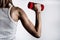 Powerful Strength: Young Woman\\\'s Back and Muscular Hand with Dumbbell