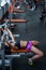 Powerful, strong, muscular girl in short shorts, performs bench press. Daylight