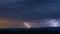 Powerful thunderstorm over hills at night