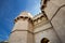 Powerful tower, old door to the city against the blue sky.