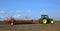 Powerful tractor transports 18 row multipurpose seed drill