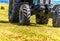 Powerful tractor wheels go over the ground up