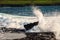 Powerful wave crushes against ragged stone coast creating splash of water. Dark dramatic light. Atlantic ocean, Doolin area,