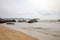 Powerful wave from sea with Rock on the beach before raining storm