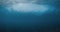 Powerful wave underwater in blue ocean. Underwater view of wave
