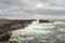 Powerful waves of Atlantic ocean crashes against strong stone cliffs. Landscape of Inishmore Aran islands, county Galway, Ireland