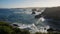 powerful waves with blue water crash on black reefs in the Atlantic Ocean