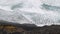 Powerful waves rolling into rocky volcanic coastline. Abandoned black sand beach on trekking trail on Santo Antao Island