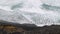 Powerful waves rolling into rocky volcanic coastline. Abandoned black sand beach on trekking trail on Santo Antao Island
