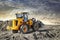 Powerful wheel loader or bulldozer working on a quarry or construction site. Earthworks in construction. Powerful modern equipment