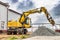 Powerful wheeled excavator at the construction site. Side view. Excavator with a wide bucket, working on a pile of rubble or