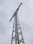 Powerline pole with three cables over a cloudy background