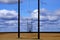 Powerlines in Field with Blue Sky and Clouds