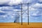 Powerlines in Field with Blue Sky and Clouds