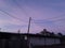 Powerlines purple and pink sunset building