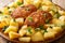 Pozharsky meatballs in breadcrumbs with a side dish of fried potatoes close-up in a plate. horizontal