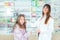 Ppharmacist giving vitamins to child girl in pharmacy drugstore