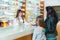 Ppharmacist giving vitamins to child girl in pharmacy drugstore