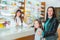 Ppharmacist giving vitamins to child girl in pharmacy drugstore