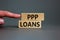 PPP, paycheck protection program loans symbol. Concept words PPP, paycheck protection program loans on blocks on a beautiful grey