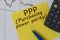 PPP word on yellow sheet on table with pen, calculator and graph