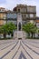 Praca de Carlos Alberto square with ornate cobblestone design leading up to the Monument to the Dead of the Great War