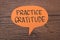 Practice Gratitude, text words typography written on paper against wooden background, life and business motivational inspirational