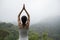 practice yoga on foggy spring mountain top