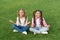 Practicing mudras during meditation. Happy children do meditation on green grass. Small girls enjoy meditation practice