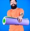 Practicing yoga every day. Man bearded athlete hold fitness mat. Fitness and stretching. Having good stretch. Athlete