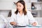 Practicioner girl in medical uniform is working with documents and laptop