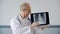 Practitioner doctor showing lung fluorography picture on laptop screen while online consultation. Pulmonologist showing