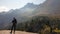 Pragser Wildsee - A man with a big hiking backpack standing at the edge of a mountain and admiring the panoramic view in front