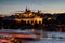 Prague castle in Hradcany with Vlatava river and lights from boats