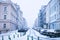 Prague city street under the snow. Cars driving on a blizzard road. Snow calamity in the city. Snow covered cars. Winter