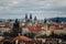 Prague, Czech Republic, 26 March 2023: Panorama of city from Petrin Hill, Red roofs, Cloudy spring day, High spires gothic towers