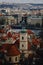 Prague, Czech Republic, 26 March 2023: Panorama of old town from Petrin Hill, Red roofs, Cloudy spring day, bell tower of Church