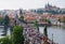 Prague, Czech Republic - August 14, 2016: Crowds of people walk on Charles Bridge - a popular tourist landmark. Prague townscape