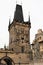 Prague, Czech Republic, January 2015. Statues of saints on the Charles Bridge and the tower above the gate.