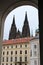 Prague, Czech Republic, January 2015. View of the royal palace and the spiers of the cathedral through the arch of the gate.