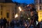 Prague, Czech Republic - July 22, 2019: Female fire dancer plays with sticks on street of old town square in Prague. Fire show.