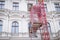 Prague, Czech Republic. March 3, 2019. Facade restoration concept. Beautiful historic Prague house and scaffold elevator