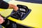 Prague, Czech republic - October 02, 2020. Yellow green electric Honda E - free car recharging on parking of Lidl shop