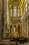 PRAGUE, CZECH REPUBLIC - OKTOBER 10, 2018: Tourists inside Vitus Cathedral near the altar with mosaic on glass window