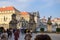 PRAGUE, CZECH REPUBLIC - OKTOBER 10, 2018: Tourists on sightseeing tours in Prague near the gate with sculptures
