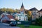 PRAGUE, CZECH REPUBLIC - OKTOBER 11, 2018: Ancient church and a modern house in Europe and yellow leaves on trees